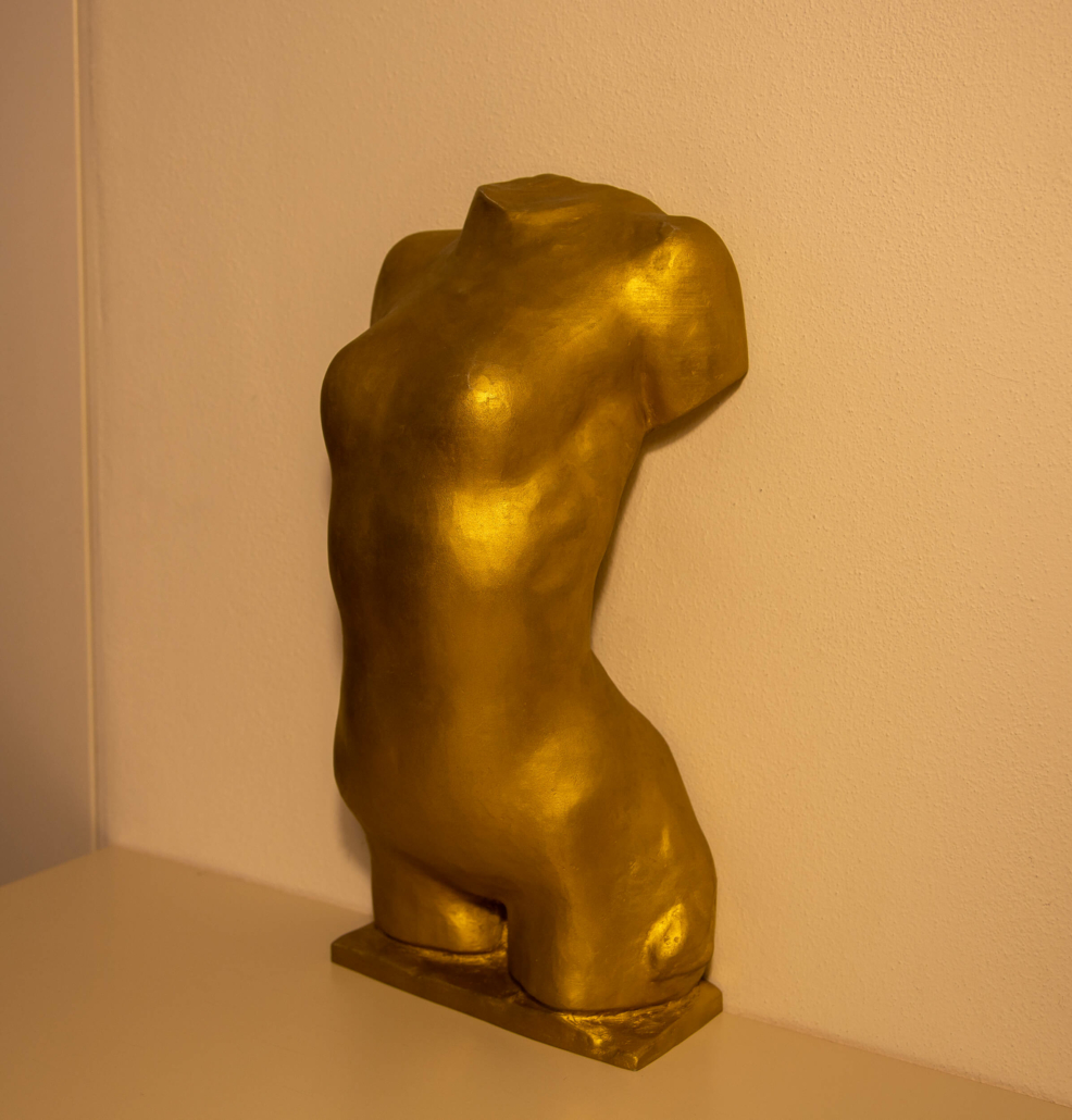Golden torso of young woman right side